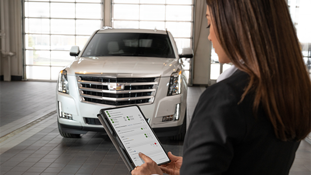 Woman on a tablet inside a Certified Service location.