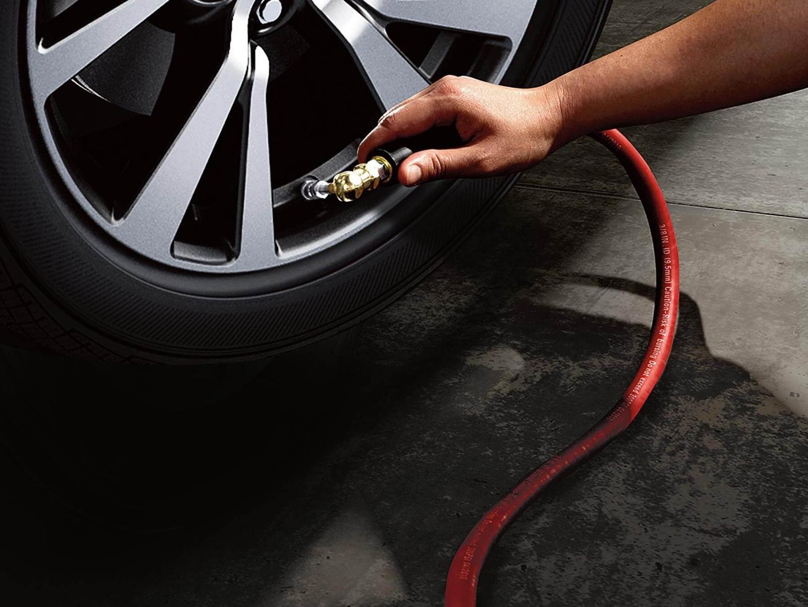 Nissan Service technician filling up tire