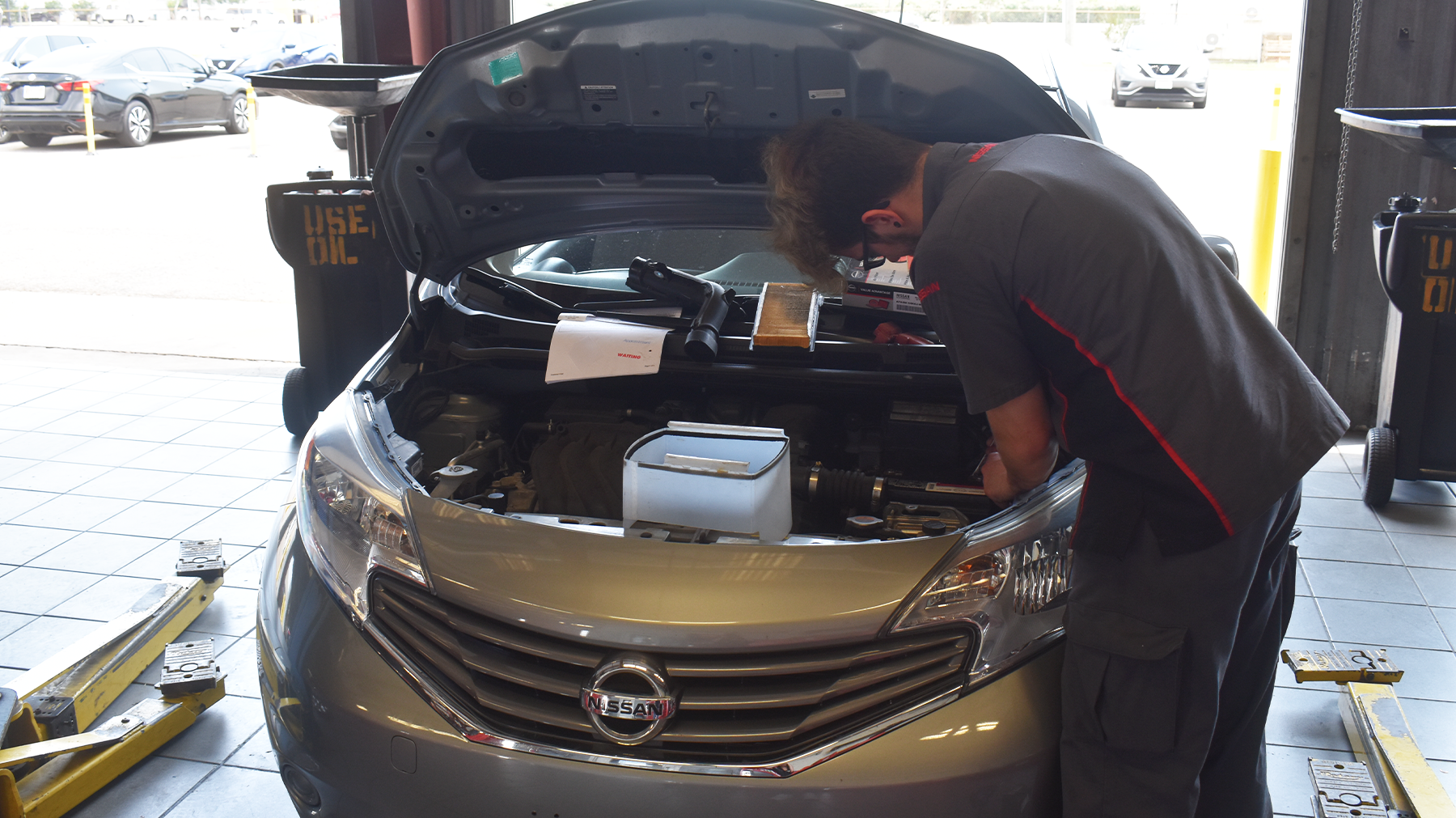 Nissan Technician doing a inspection on a vehicle