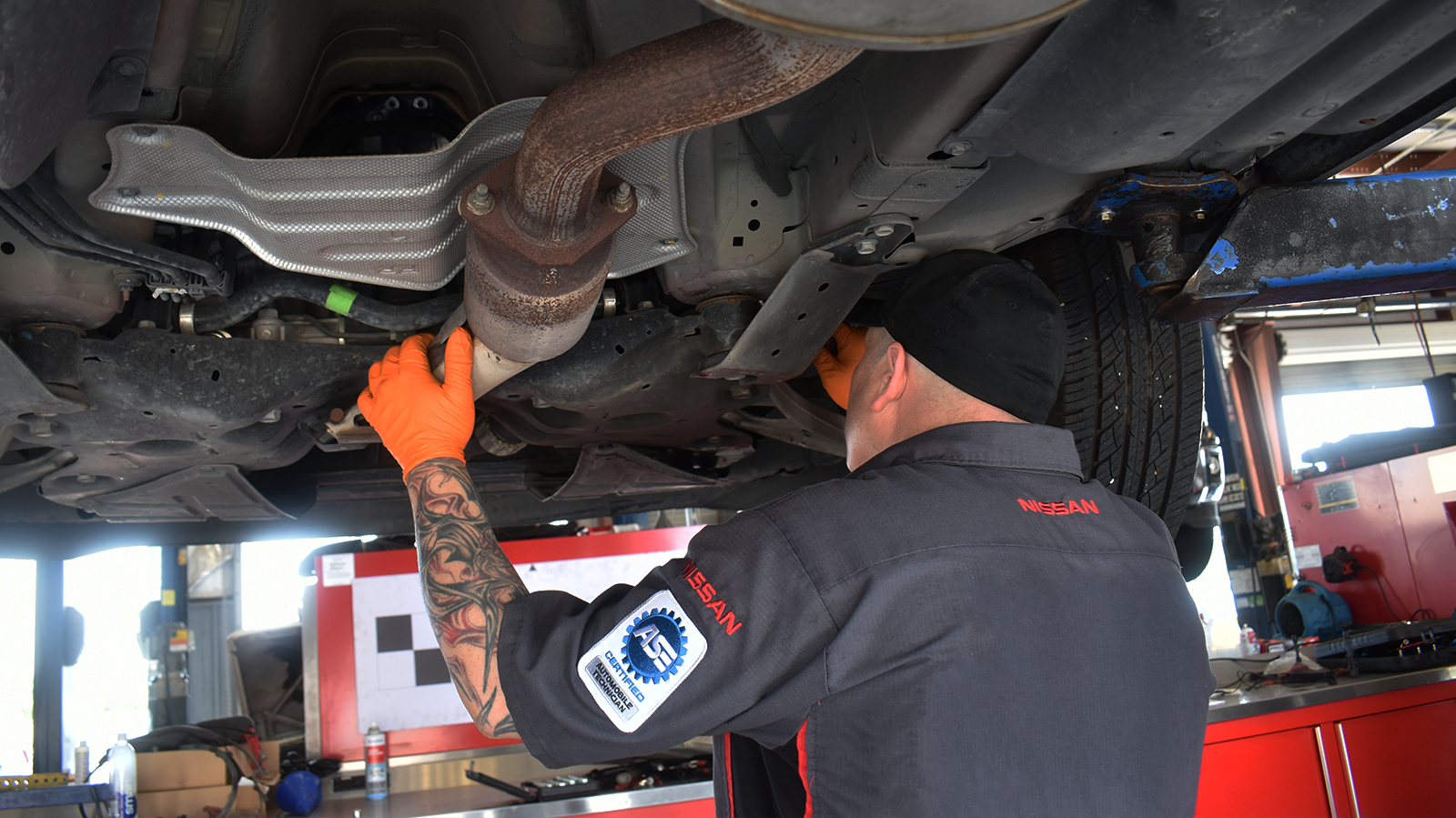 Nissan Technician Changing the Filter on Vehicle