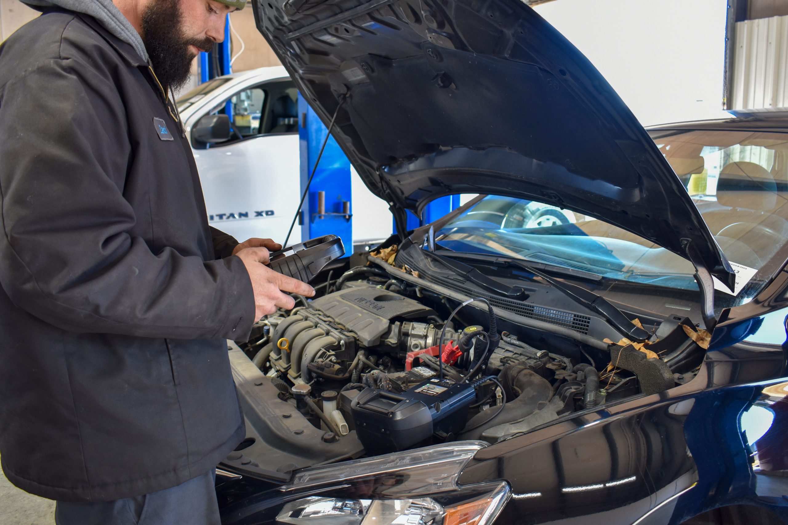 Nissan Technician doing a inspection on a vehicle