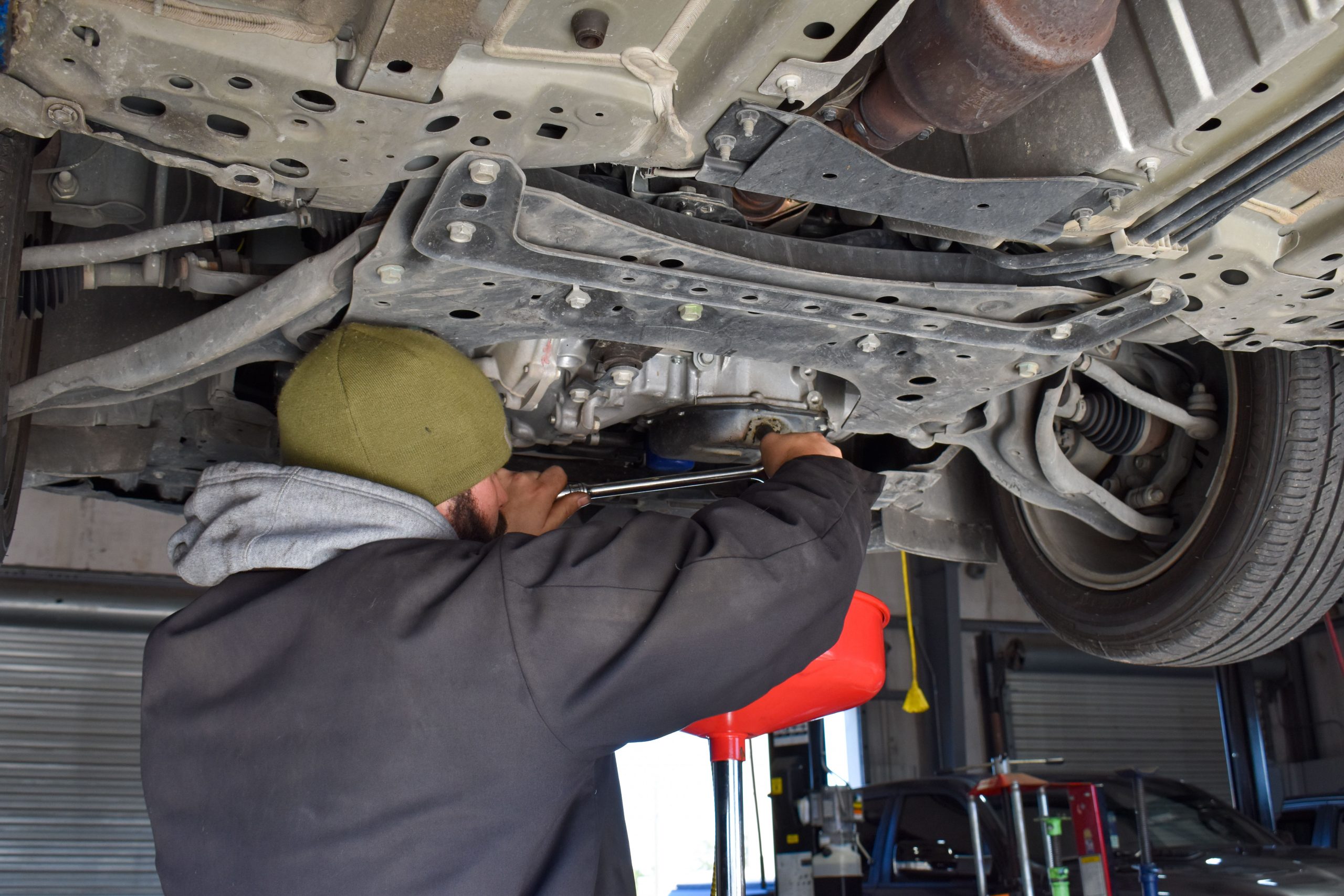 Nissan Technician Changing the Filter on Vehicle