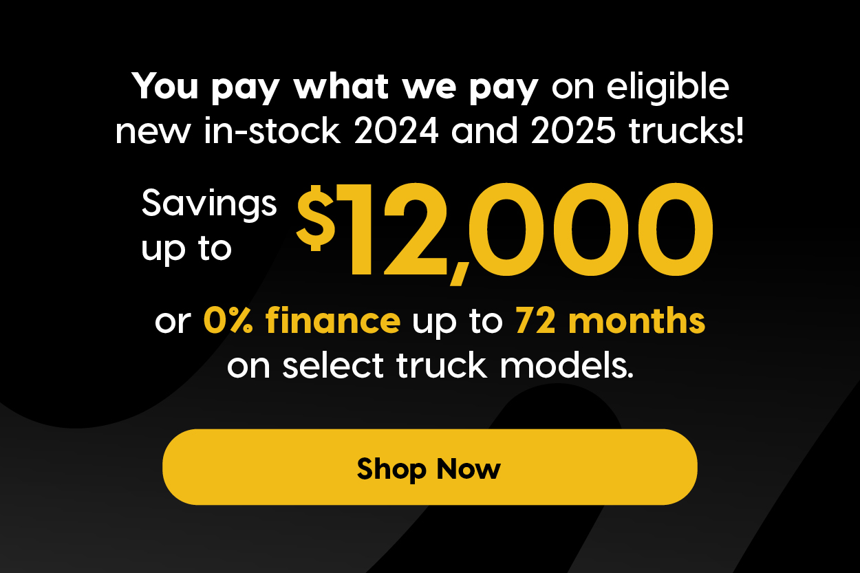 A promotional ad featuring a black GMC truck driving on a winding road through a scenic, forested mountain landscape. Headline in white on black background with a dollar sign icon: "Employee Pricing Event" Promotional Offer Text: "You pay what we pay on eligible new in-stock 2024 and 2025 trucks!" Savings up to $12,000 0% finance up to 72 months on select truck models
