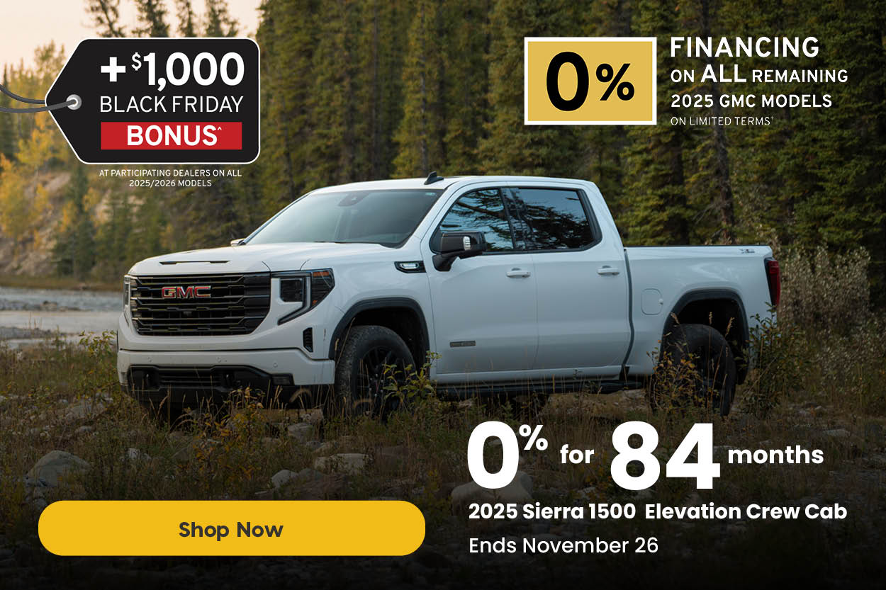 White 2025 GMC Sierra 1500 Elevation Crew Cab parked beside a rocky riverside surrounded by trees. Text overlay reads: “+$1,000 Black Friday Bonus at participating dealers on all 2025/2026 models. 0% for 84 months on the 2025 Sierra 1500 Elevation Crew Cab. Ends November 26.” A yellow button reads “Shop Now.”