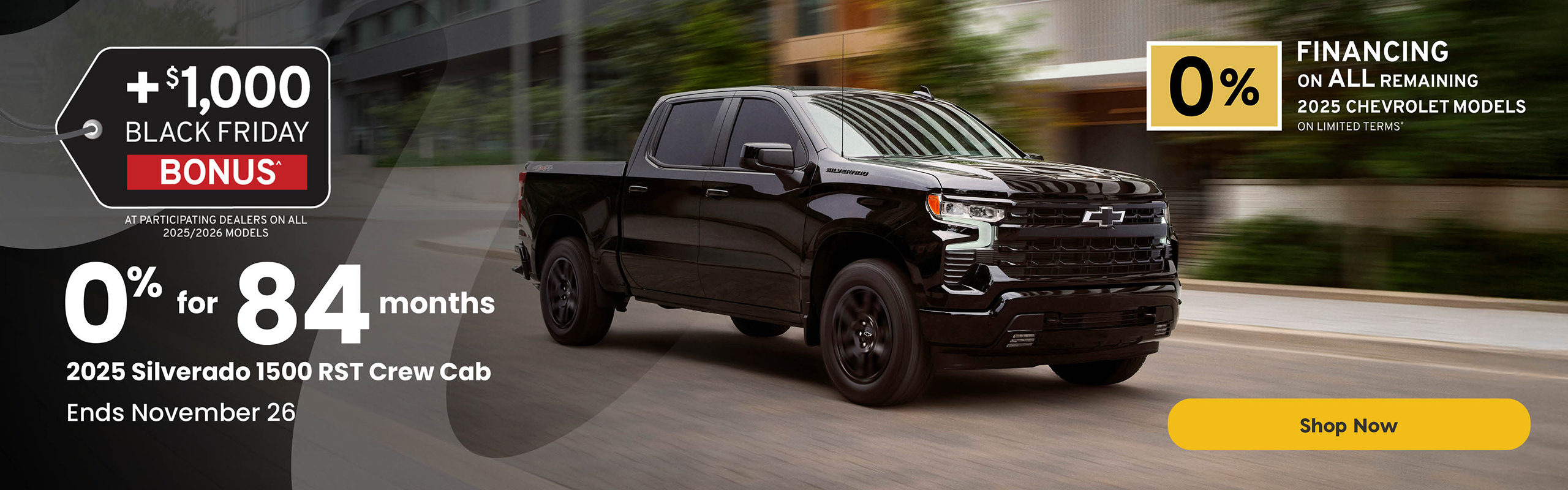 Black 2025 Chevrolet Silverado 1500 RST Crew Cab driving through a city street. Text reads: “+$1,000 Black Friday Bonus at participating dealers on all 2025/2026 models. 0% for 84 months on the 2025 Silverado 1500 RST Crew Cab. Ends November 26.” A yellow button reads “Shop Now.”