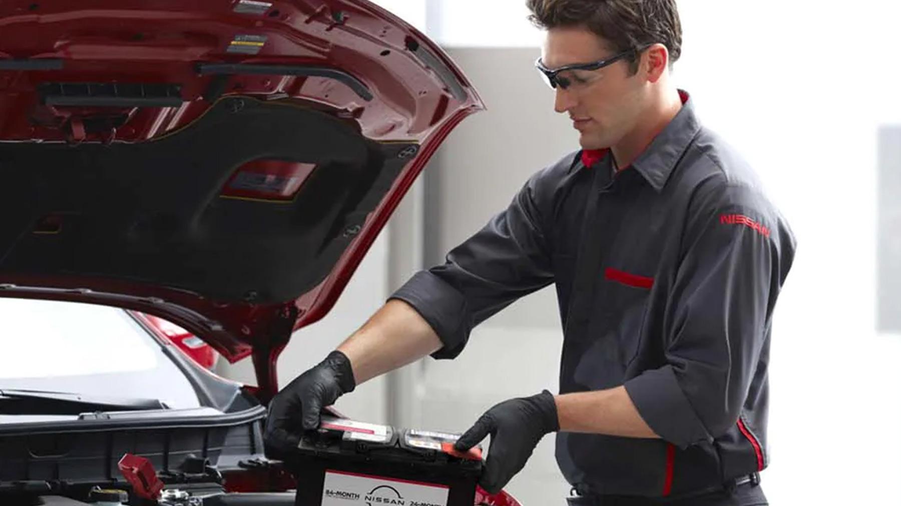 Nissan Technician doing a inspection on a vehicle