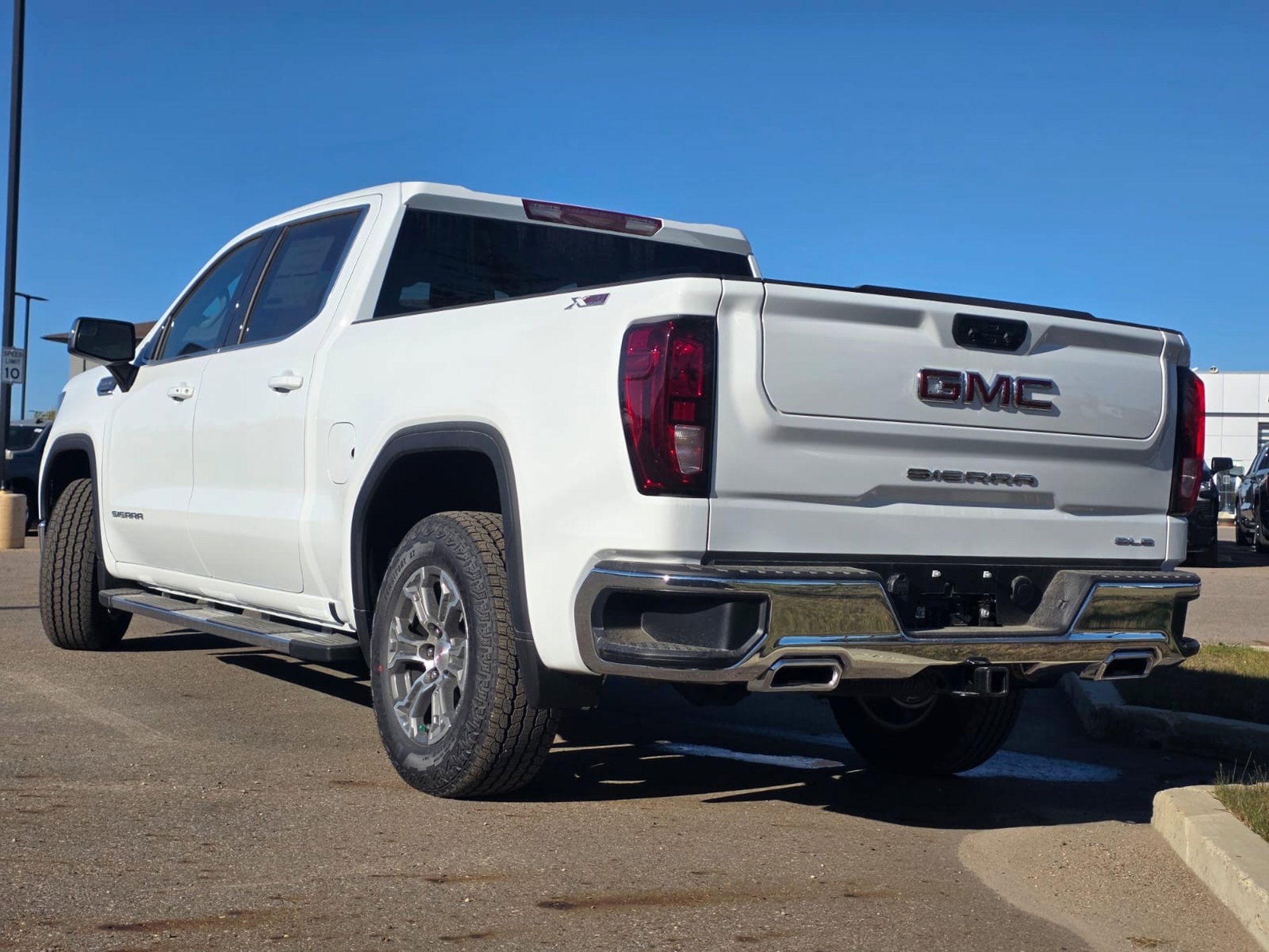 Rear 3/4 view of the GMC Sierra 1500, showcasing its truck bed