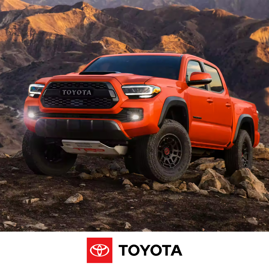 Red 2023 Toyota Tacoma on rocks