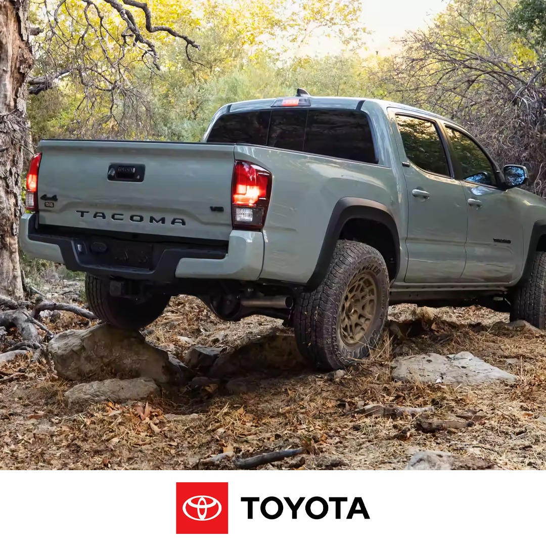 Grey 2023 Toyota Tacoma outdoors with left rear tire on a rock