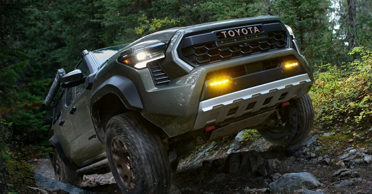 2026 Toyota Tacoma driving uphill on a rocky terrain
