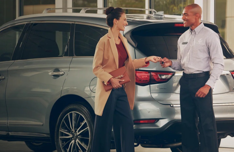 Man and woman at an INFINITI dealership