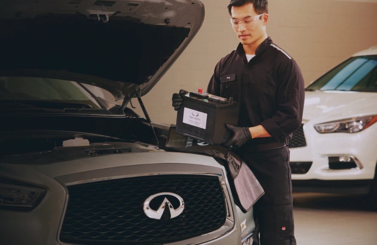 Service technician replacing battery in an INFINITI