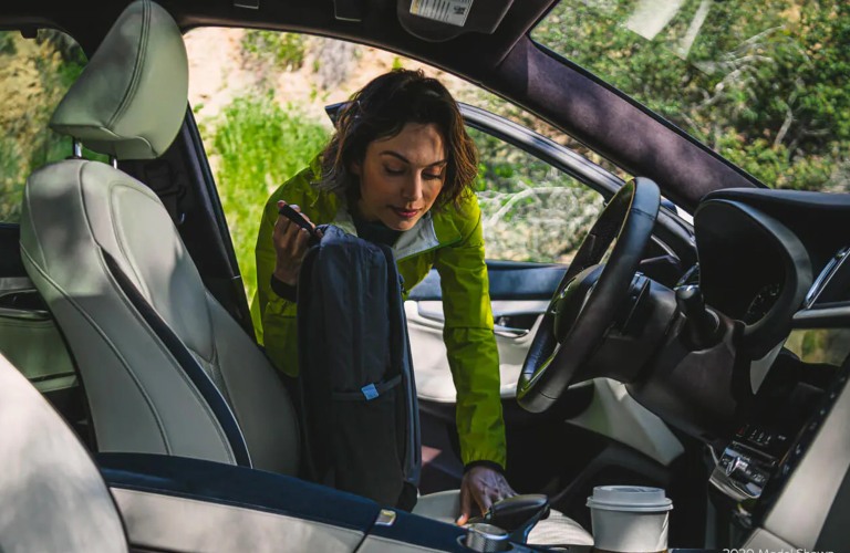 2022 INFINITI QX50 interior front seat with woman in yellow getting in