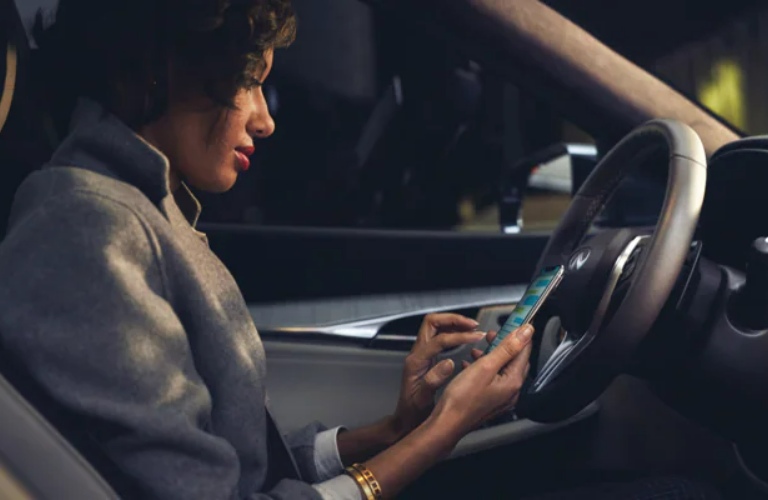 2022 INFINITI QX50 with woman in the driver's seat
