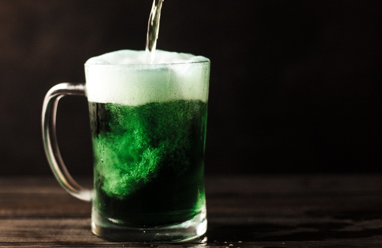 Green beer being poured