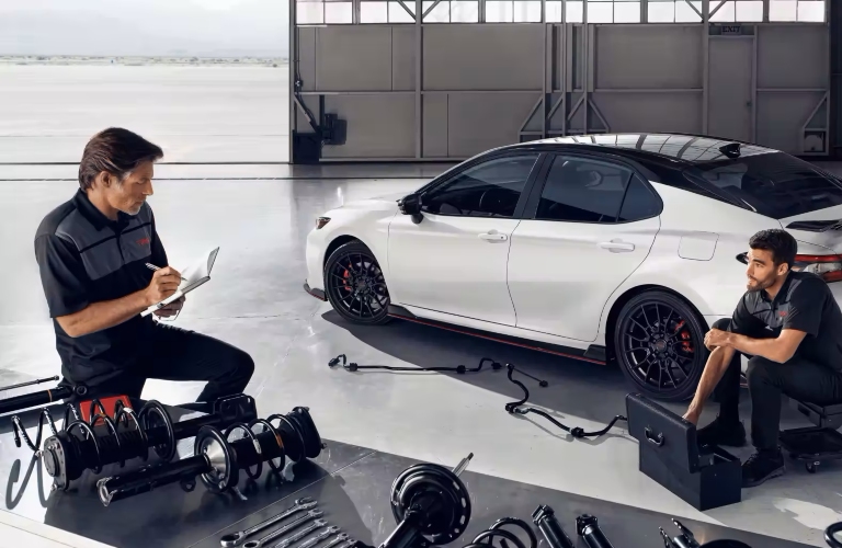 mechanics working on toyota camry hybrid