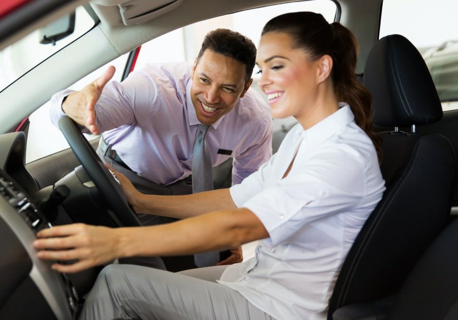 friendly car salesman helping a customer