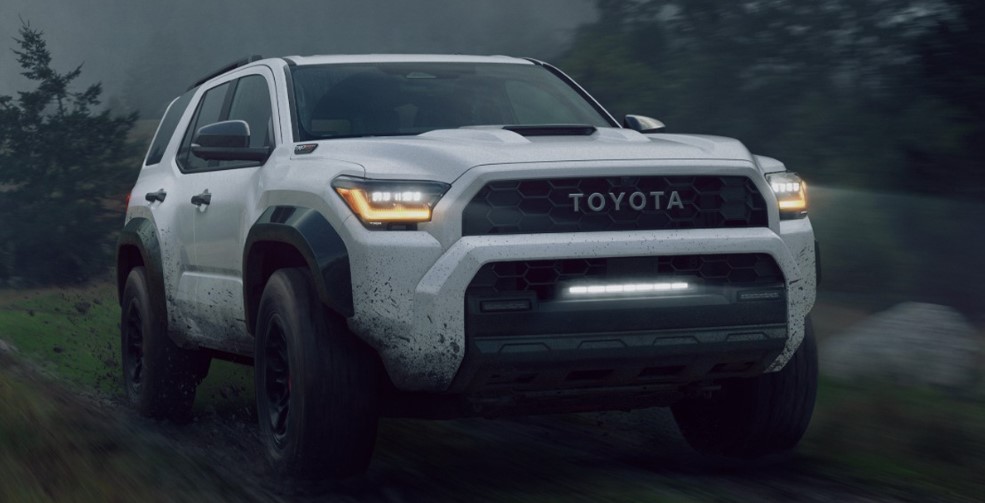 white 2025 toyota runner cruising through mud,