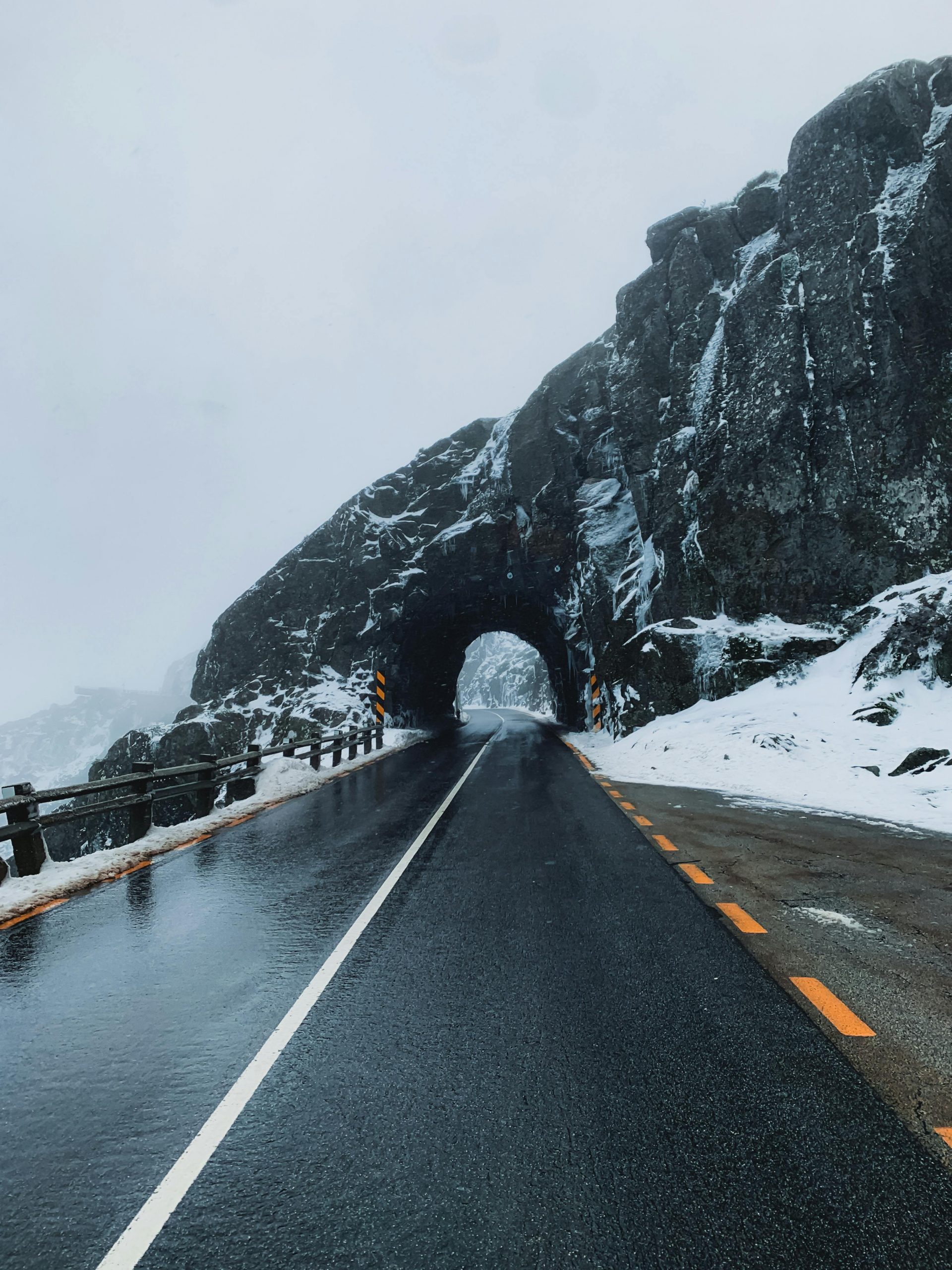 A snowy street scene depicting black ice and snow drifts in a winter setting.