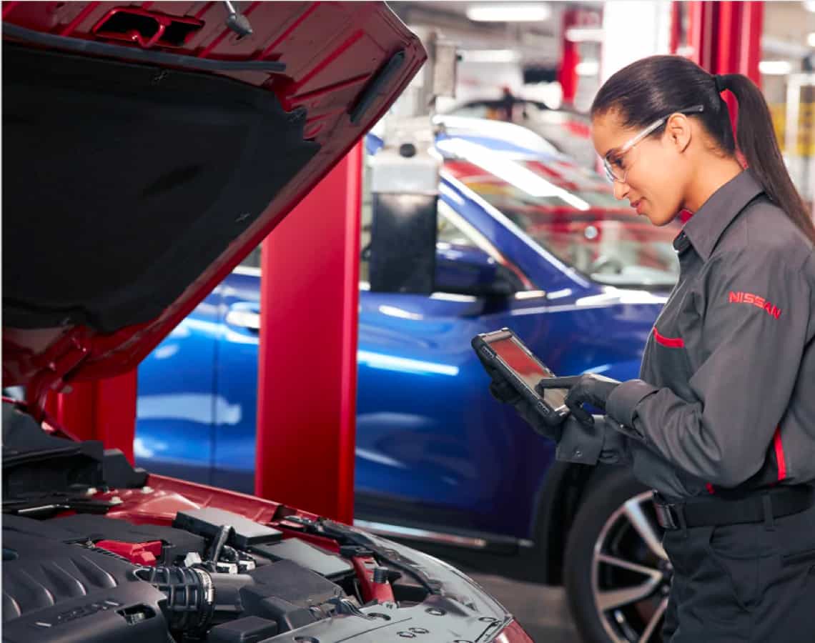 Service technician inspecting vehicle