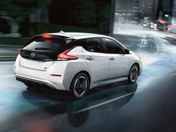 2025 Nissan LEAF driving down a road