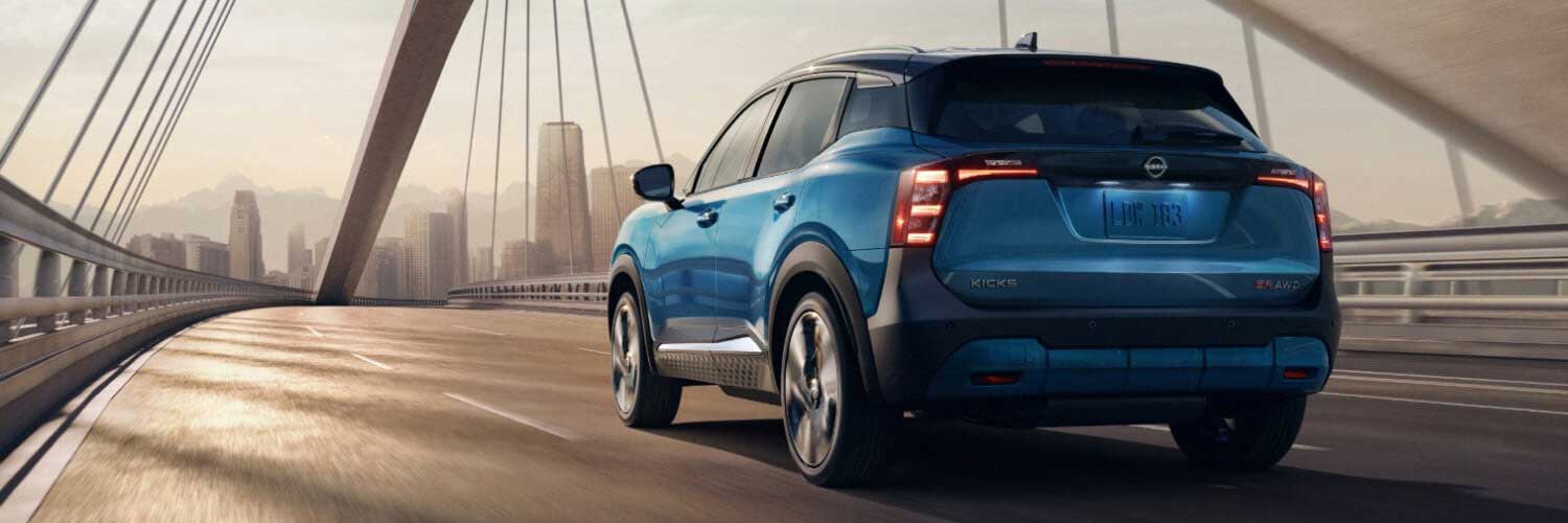 2026 Nissan Kicks driving across a bridge