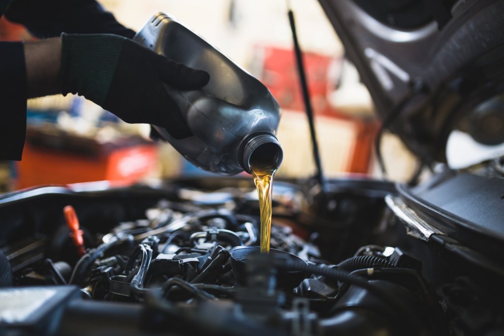 a mechanic changing the oil in a car