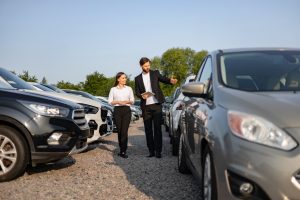 Sales-Consultant-Showing-Vehicle-Options-to-a-Customer