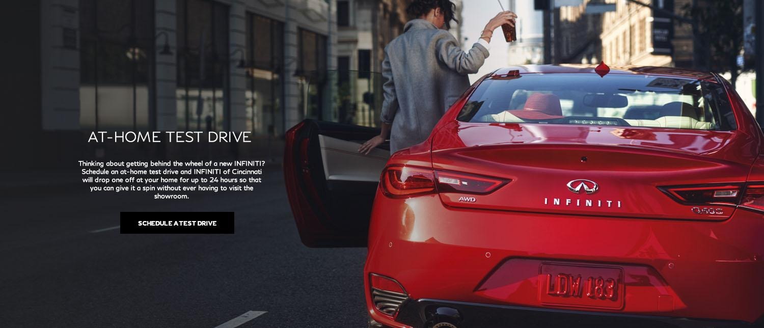 Schedule an at home test drive with INFINITI of Cincinnati. Image of woman entering a red Q60.