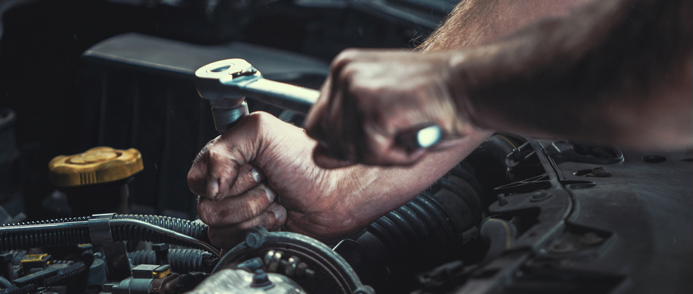 mechanic working on engine block