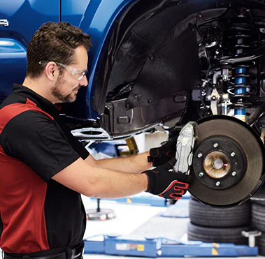 Toyota Technician working on brakes