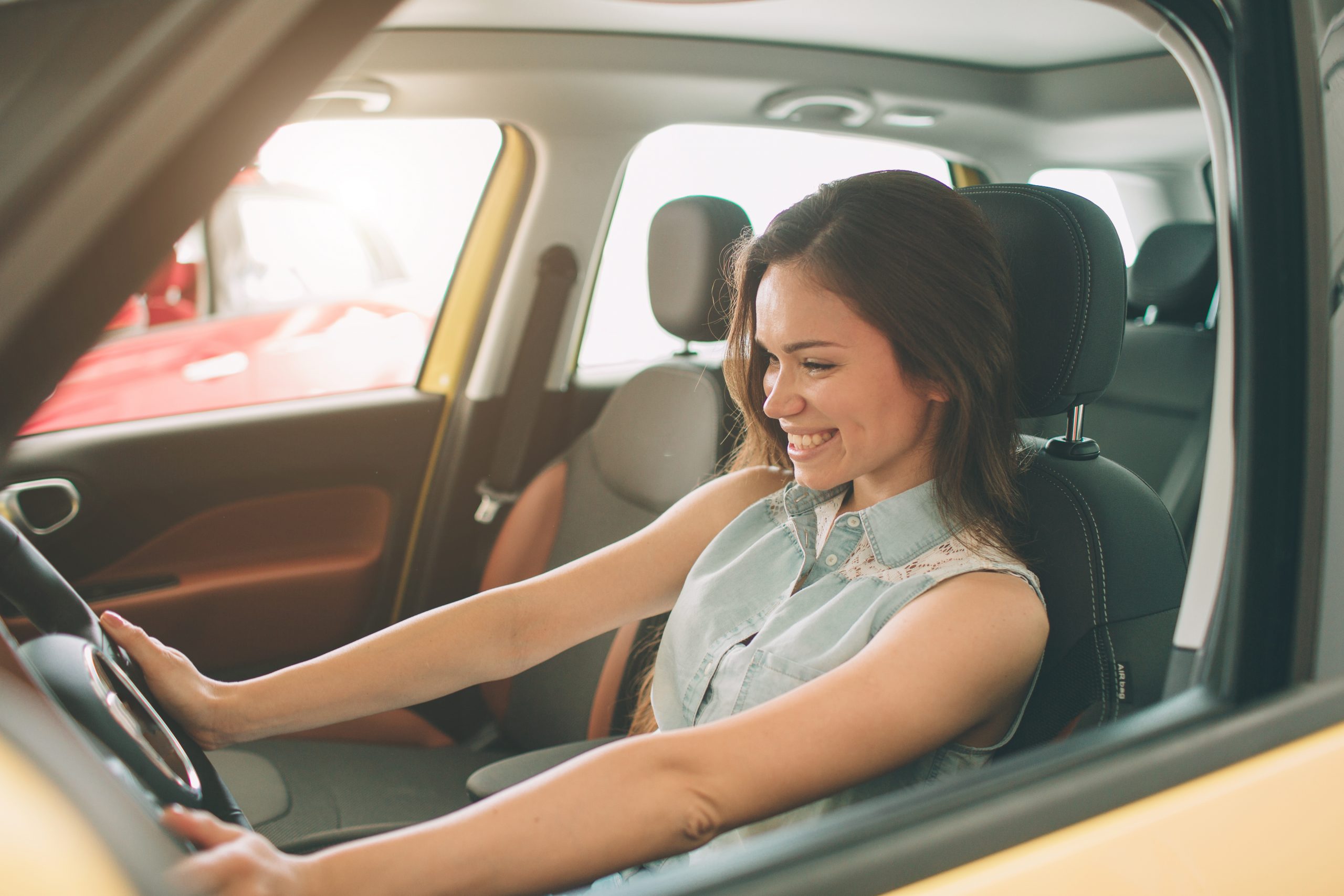 Woman smiling in a new car