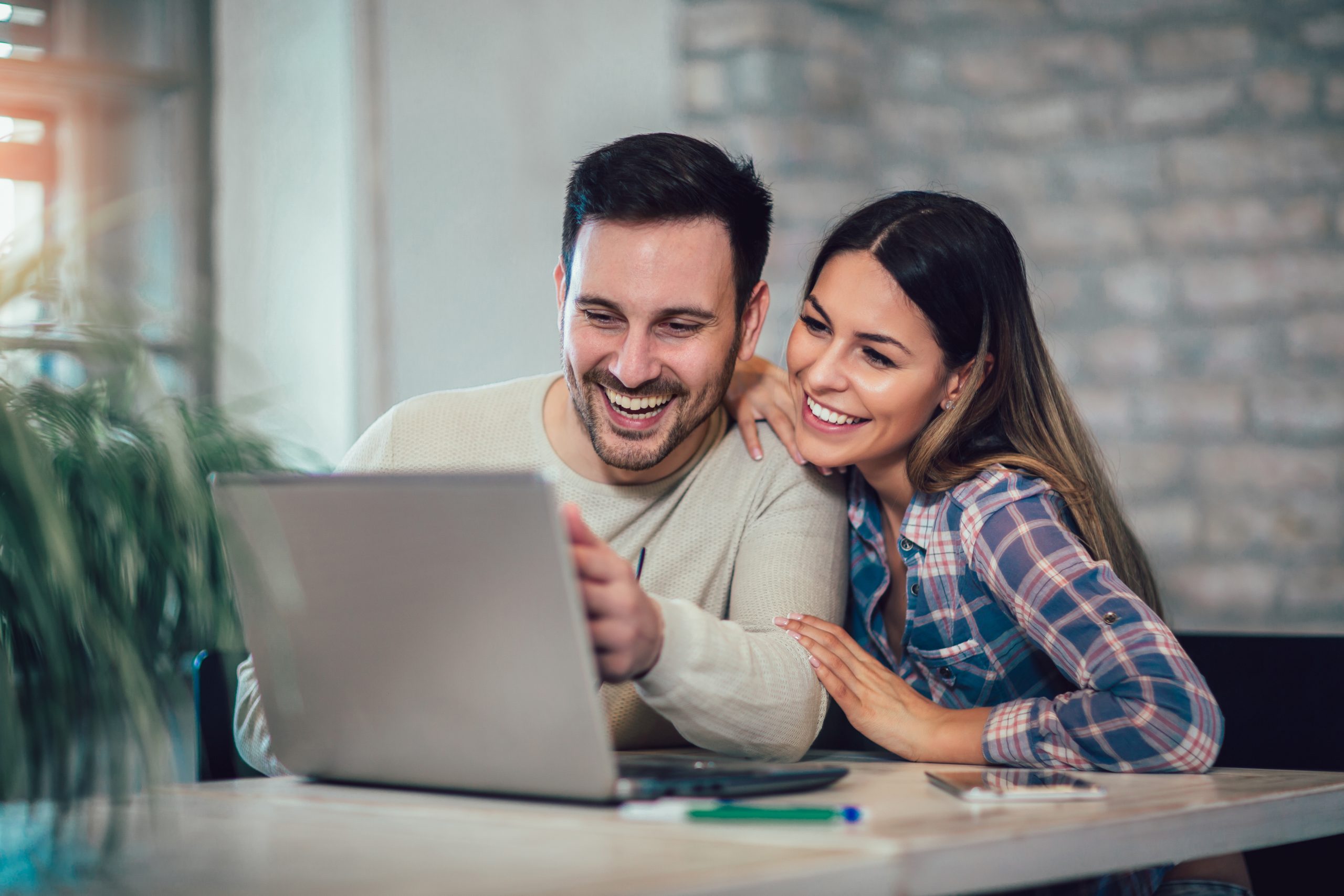 Couple looking at computer smiling