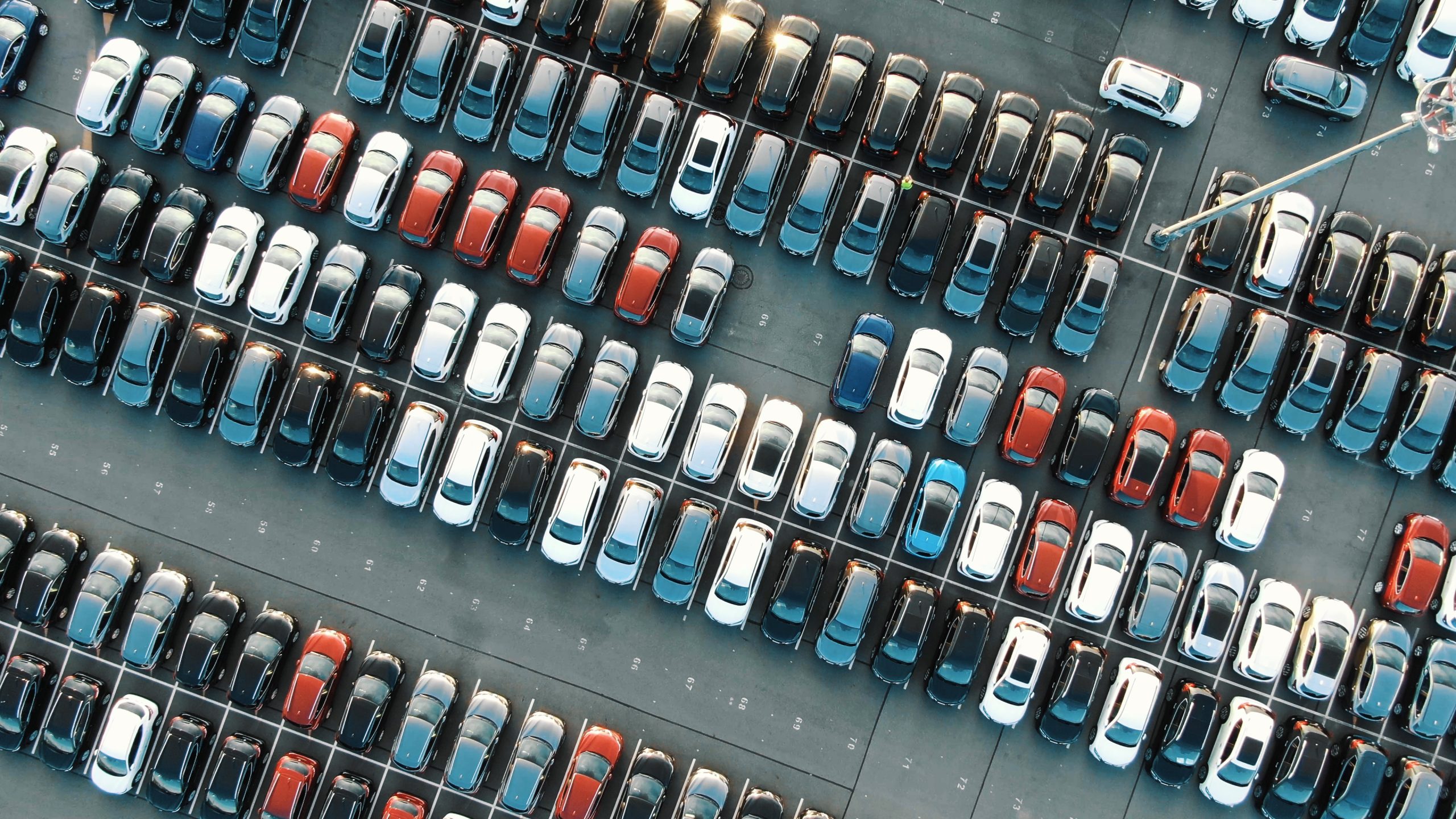 Car lot aerial view with lots of different cars