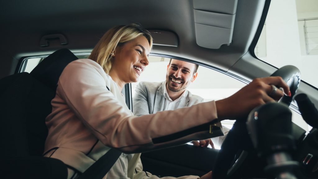 Woman sitting in car before test drive