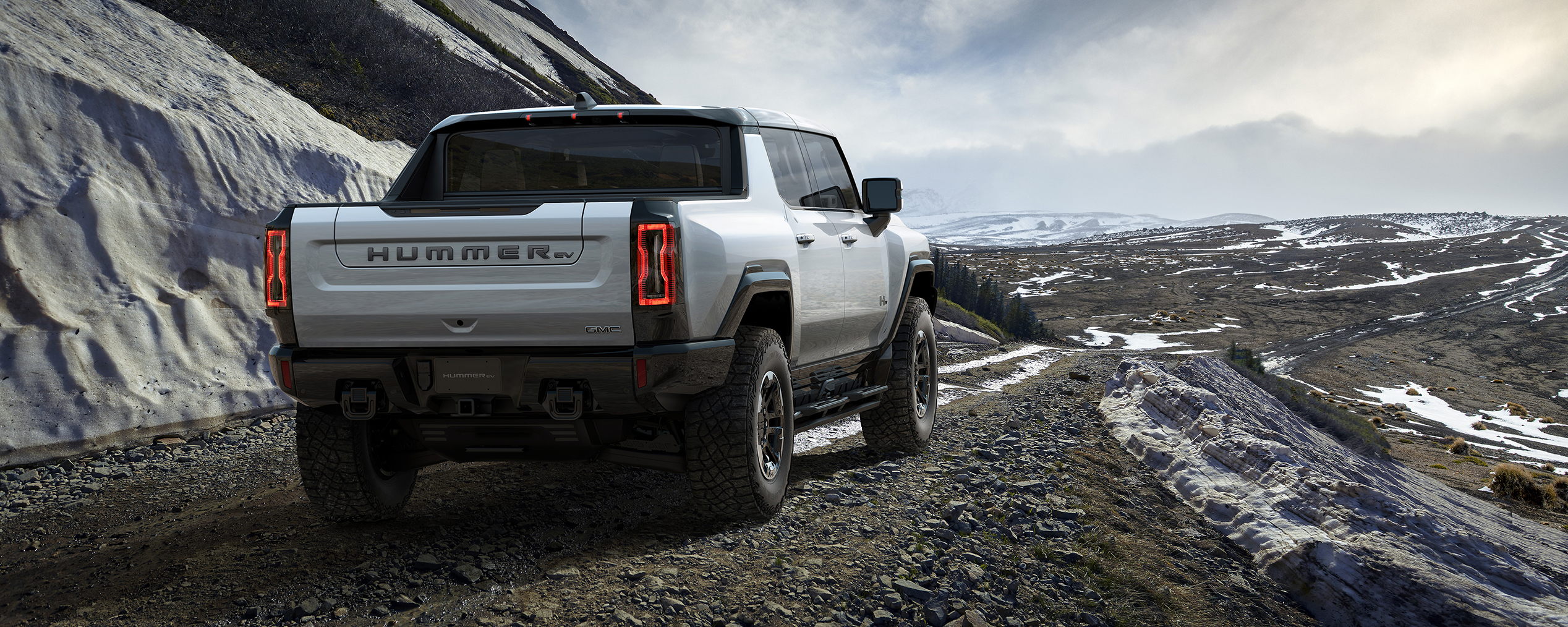 2024 Hummer EV pickup driving on a mountain ridge