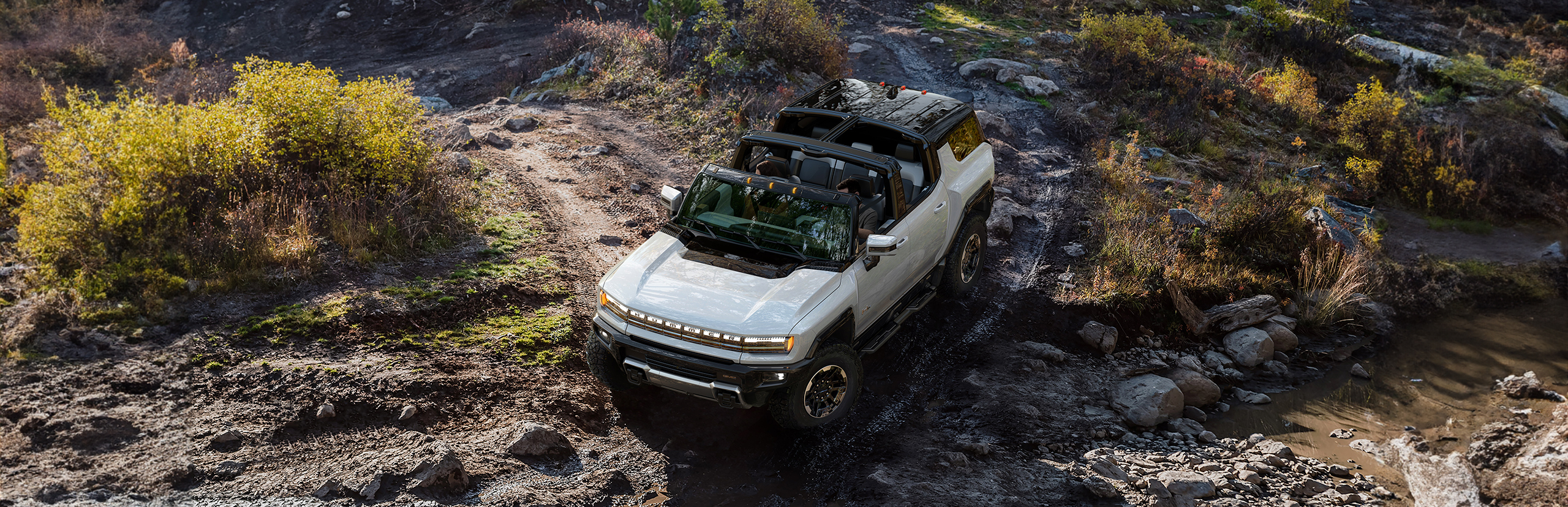 2024 Hummer EV driving through mud