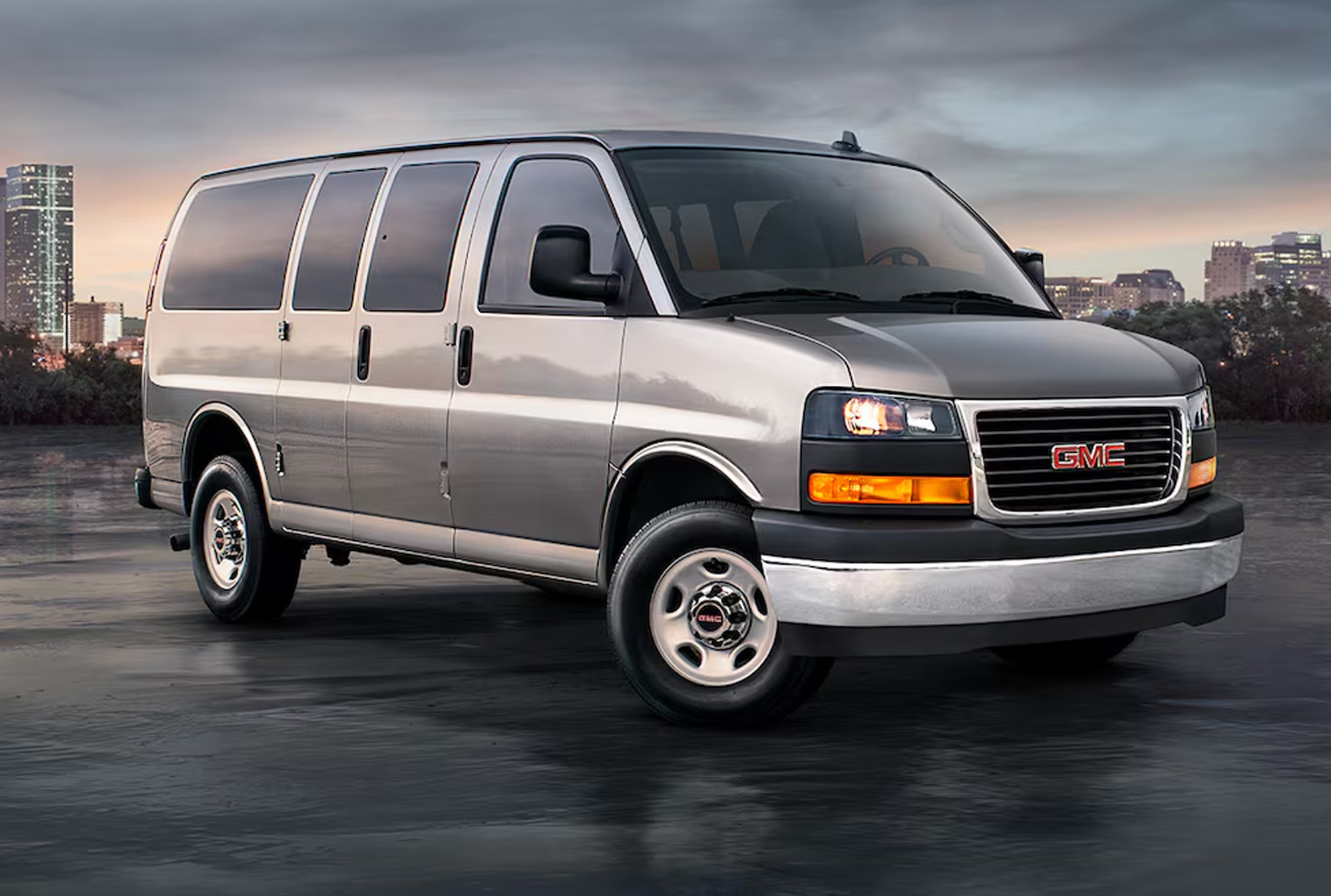 2025 GMC Savana Passenger Van against a city skyline