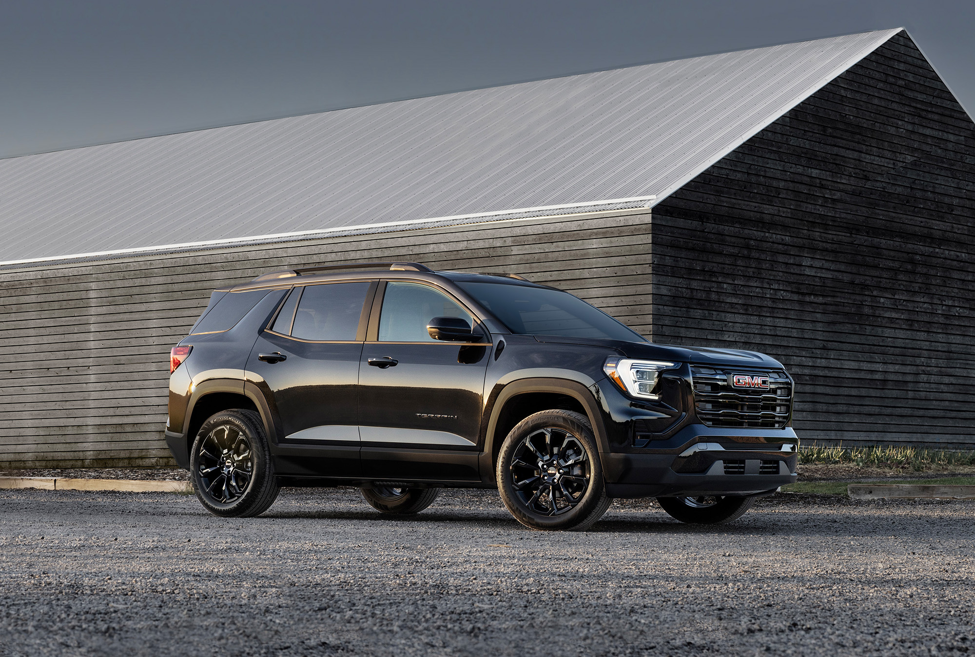 2025 GMC Terrain Elevation parked outside a wooden house