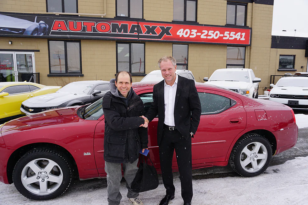 happy customer buying a car at our used car dealership in Calgary