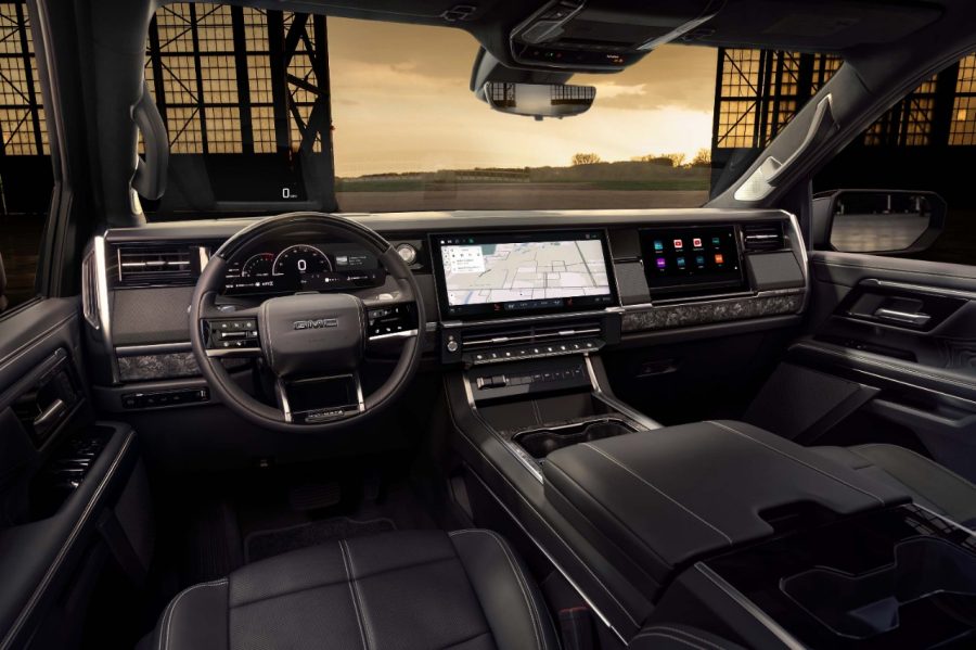 Interior view of the 2027 GMC Sierra 1500 dashboard, steering wheel, and infotainment display
