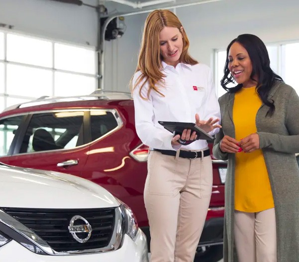 service person speaking with customer at dealership