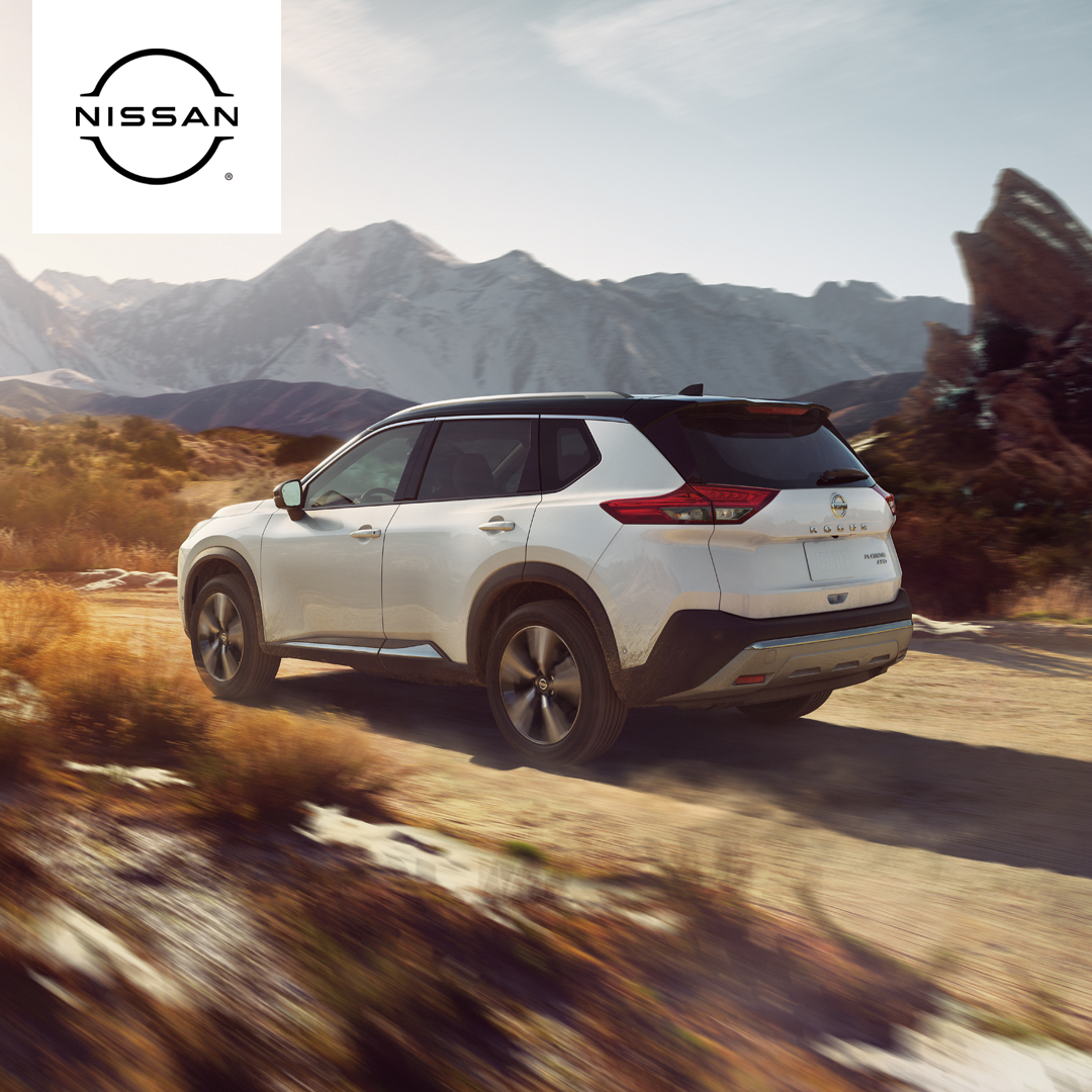 White 2023 Nissan Rogue Driving in the Desert