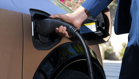 Charging outlet being plugged into a Nissan EV