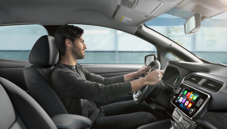 Interior shot of man driving a Nissan EV